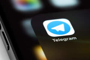 Image of phone with Telegram logo on it